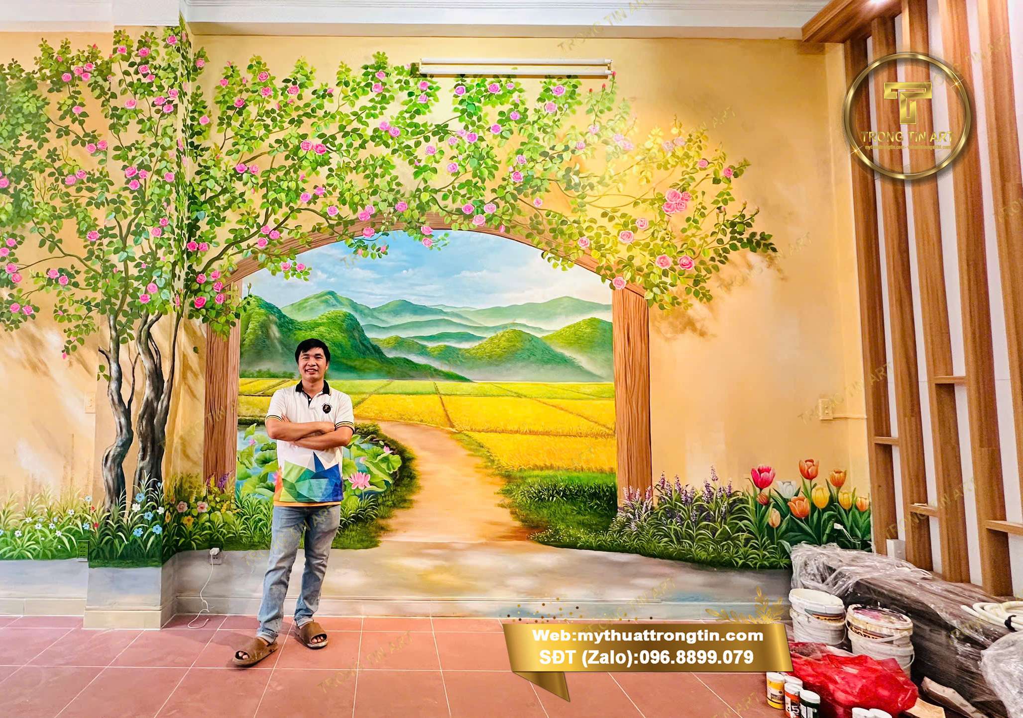 Đơn Vị Vẽ Tranh Tường 3D,Vẽ tranh tường phong cảnh 3D đồng quê với cánh đồng lúa, cổng vòm hoa và núi non, thi công bởi Mỹ thuật Trọng Tín tại quán cà phê.
